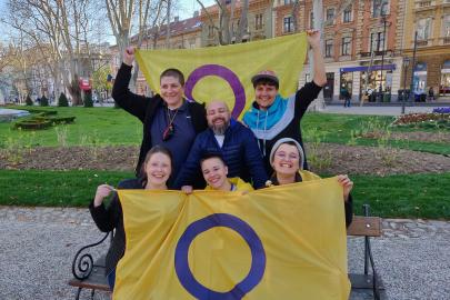 Trans and Intersex Balkan march, group pose with two intersex flags