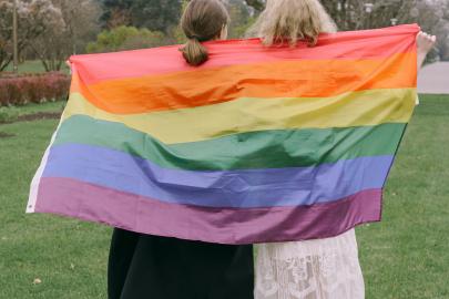 People holding a pride flag