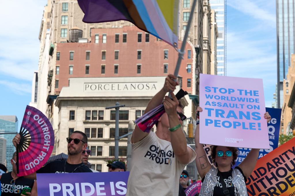 Person holding inclusive pride flag