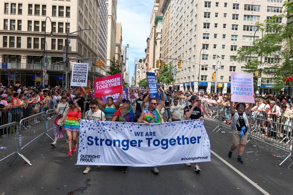 Large group photo of people marching in the street during NY Pride