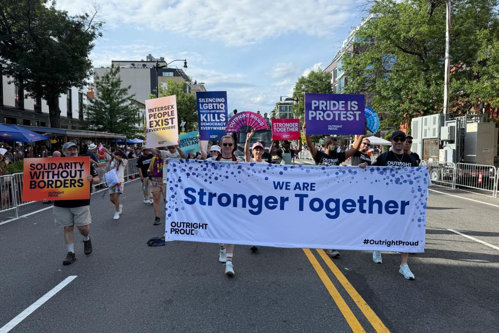 Large group photo of people marching in the street during WorldPride