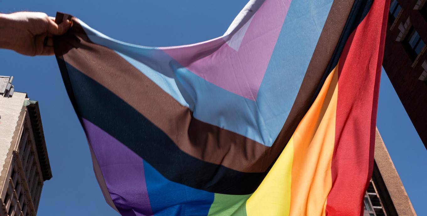 inclusive rainbow flag flying mid air