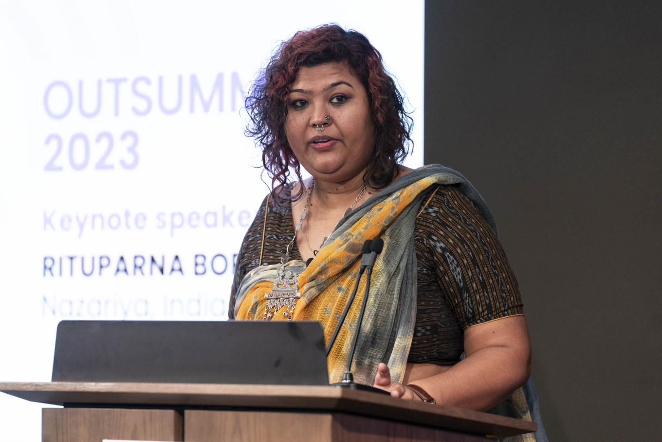 Rituparna Borah speaking at the podium