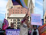 Person holding inclusive pride flag