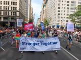 Large group photo of people marching in the street during NY Pride