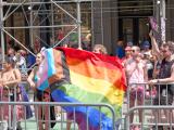 Person holding inclusive pride flag