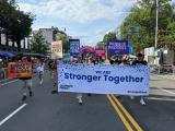 Large group photo of people marching in the street during WorldPride