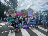 Large group photo of people marching in the street during WorldPride